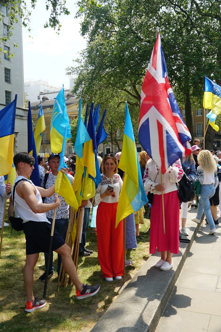 group of people with flags of ukraine and uk